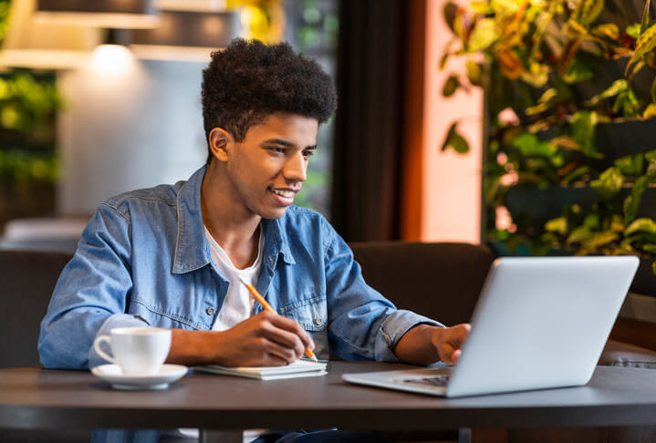 A young founder deep in work at his laptop